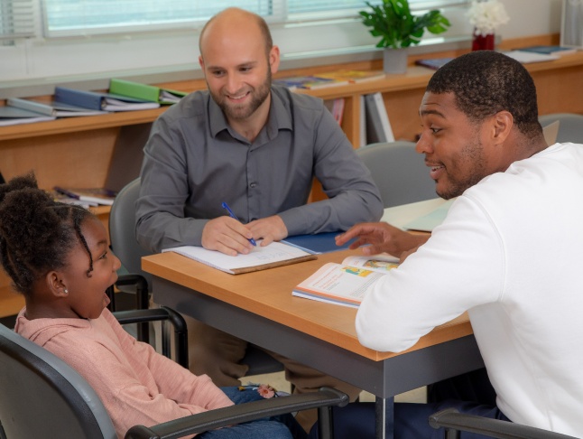 Educator, parent, & student discussing.