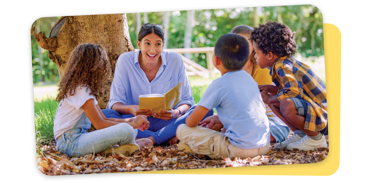 A teacher working with students outdoors